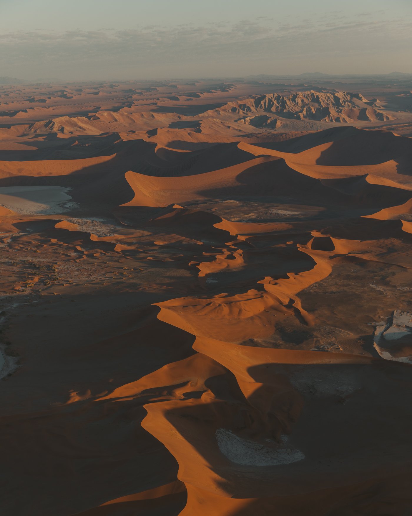 Aerial view of Sossusvlei dunes and clay pans at sunrise, Namibia